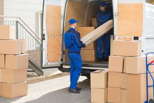 Furniture removals team handling bulky items in a Lambeth street