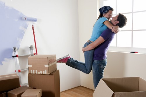 Professional movers carefully carrying furniture in a Lambeth property