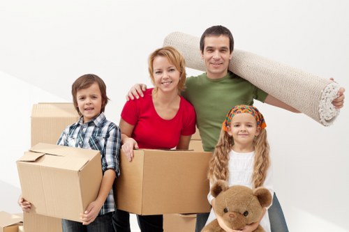 Professional movers handling office furniture in a Lambeth street